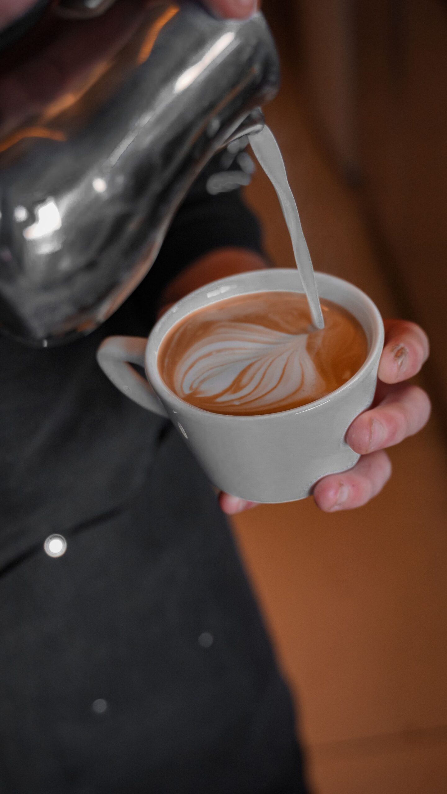 A latte with heart latte art on a saucer