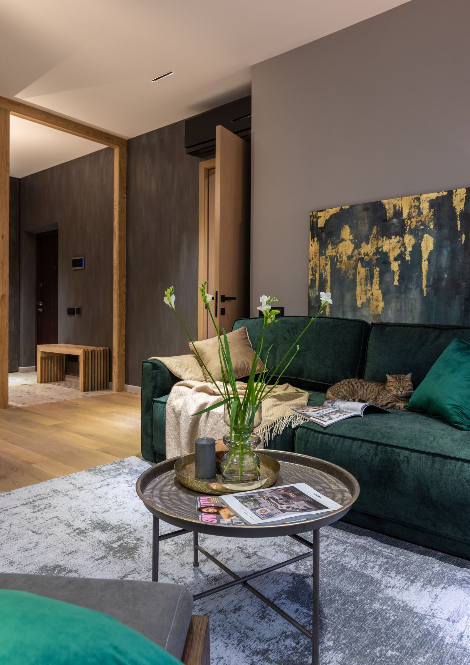 Styled living room with an olive sofa, artwork and a floor lamp