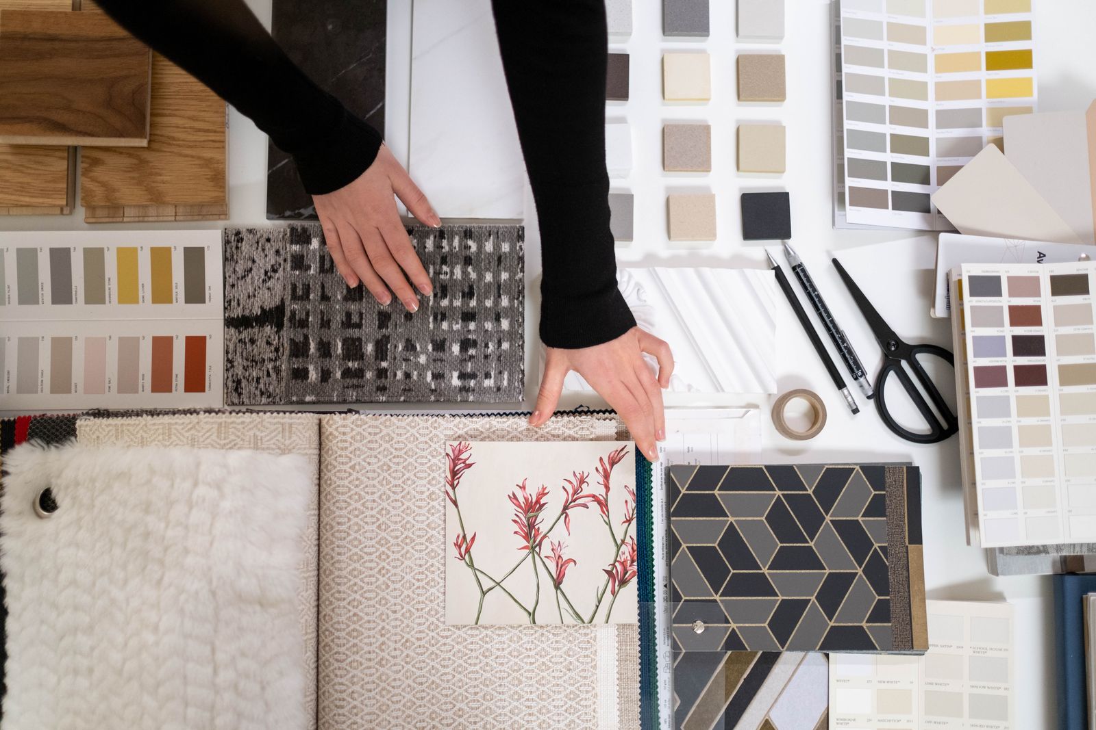 Designer pinning colour and fabric samples to a mood board
