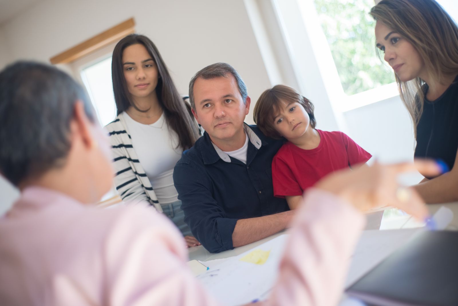 An insurance agent talking with a family at a desk