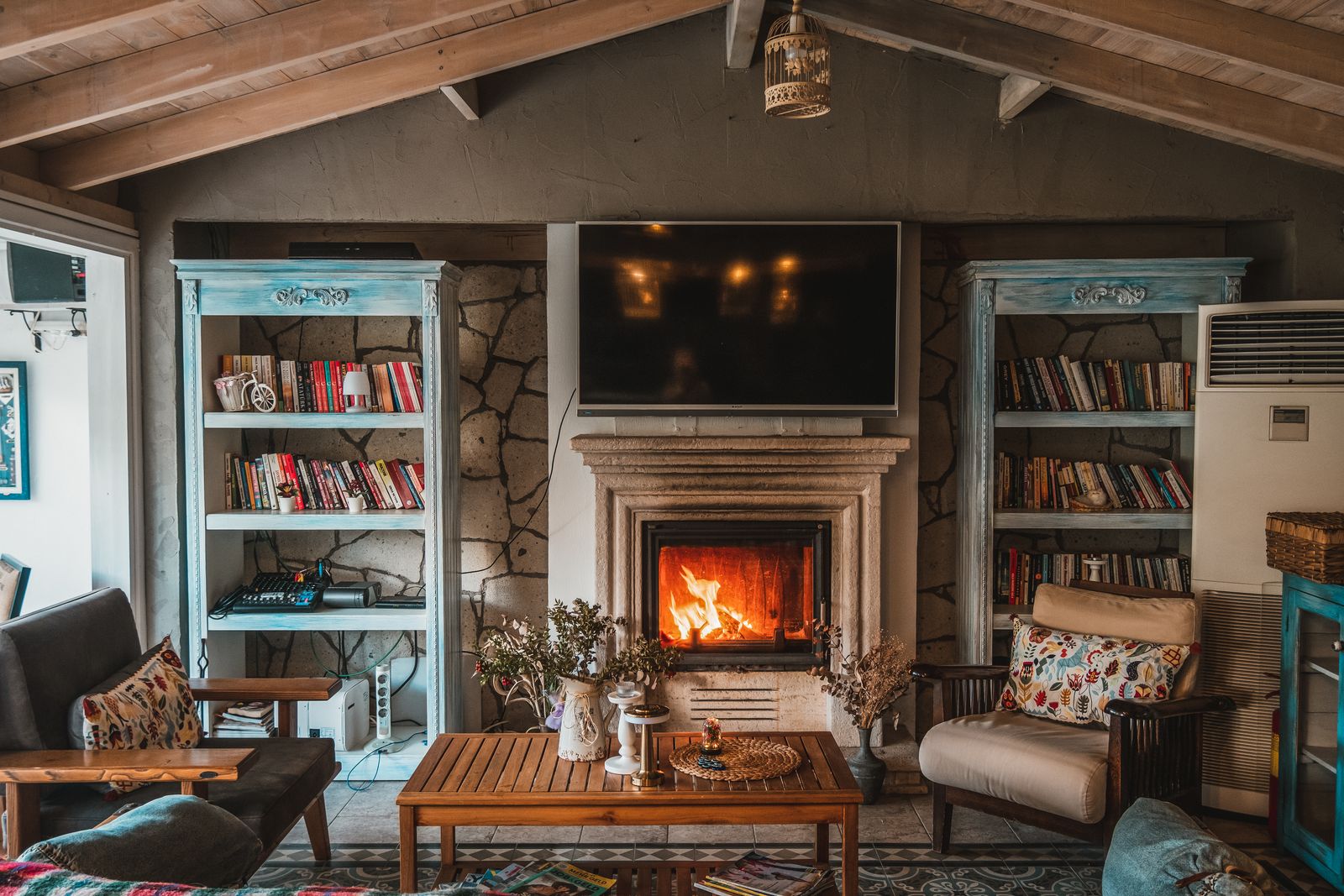 The guest lounge with armchairs and an open fire