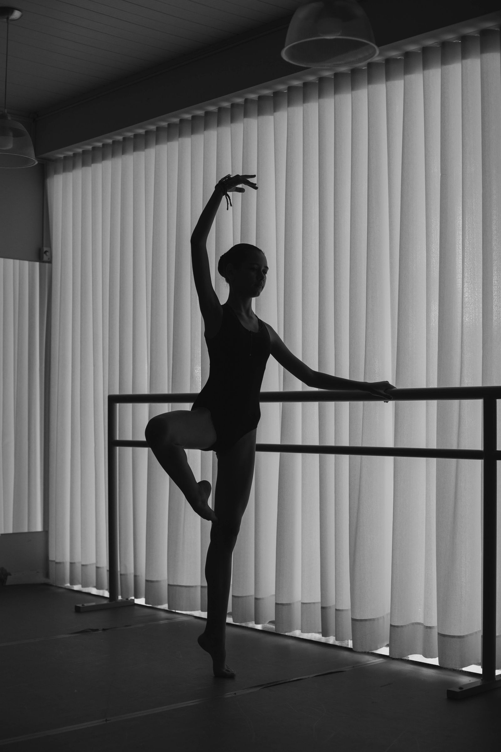 Ballet dancer with her arms raised above her head