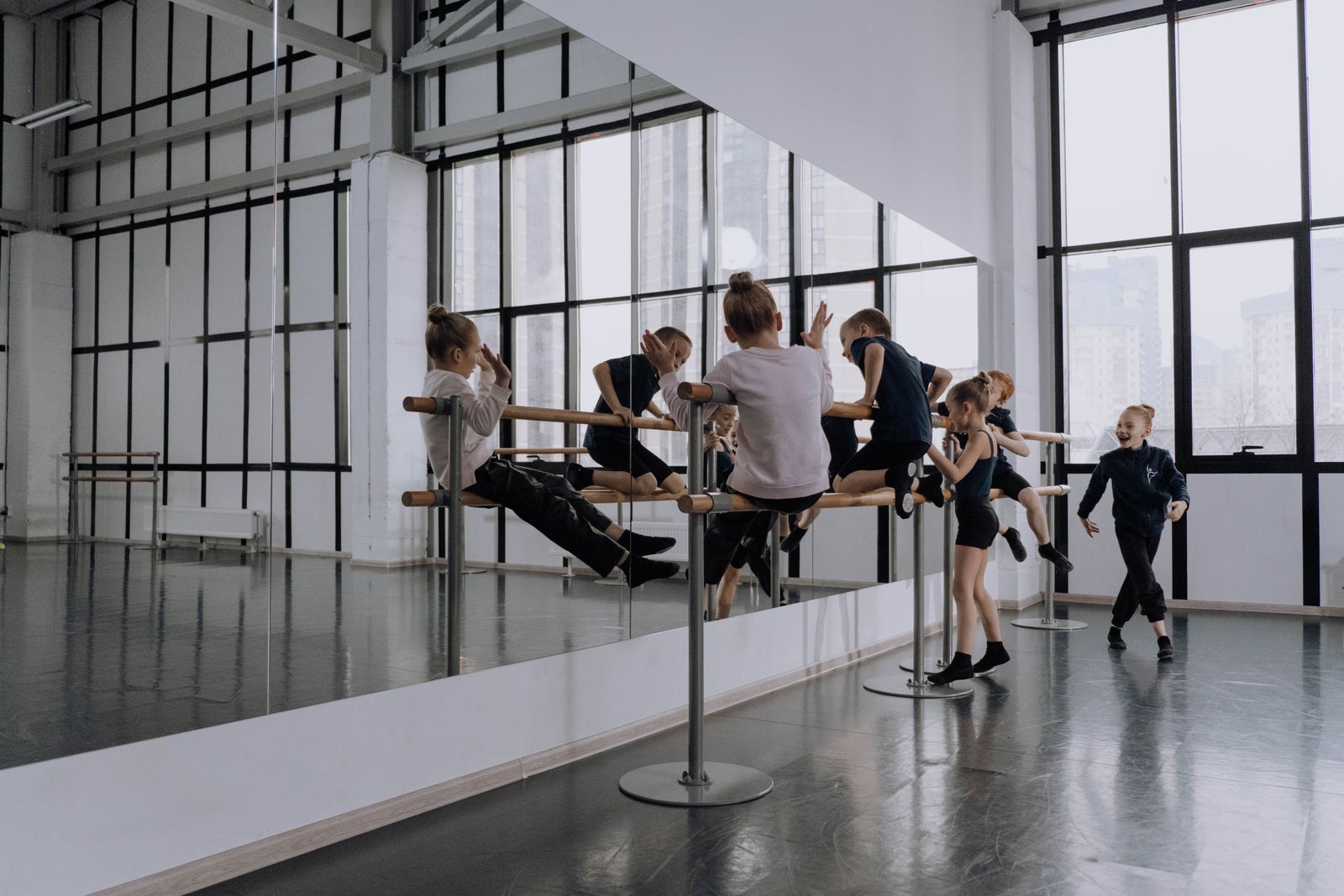Bright dance studio with a barre and a wall of mirrors