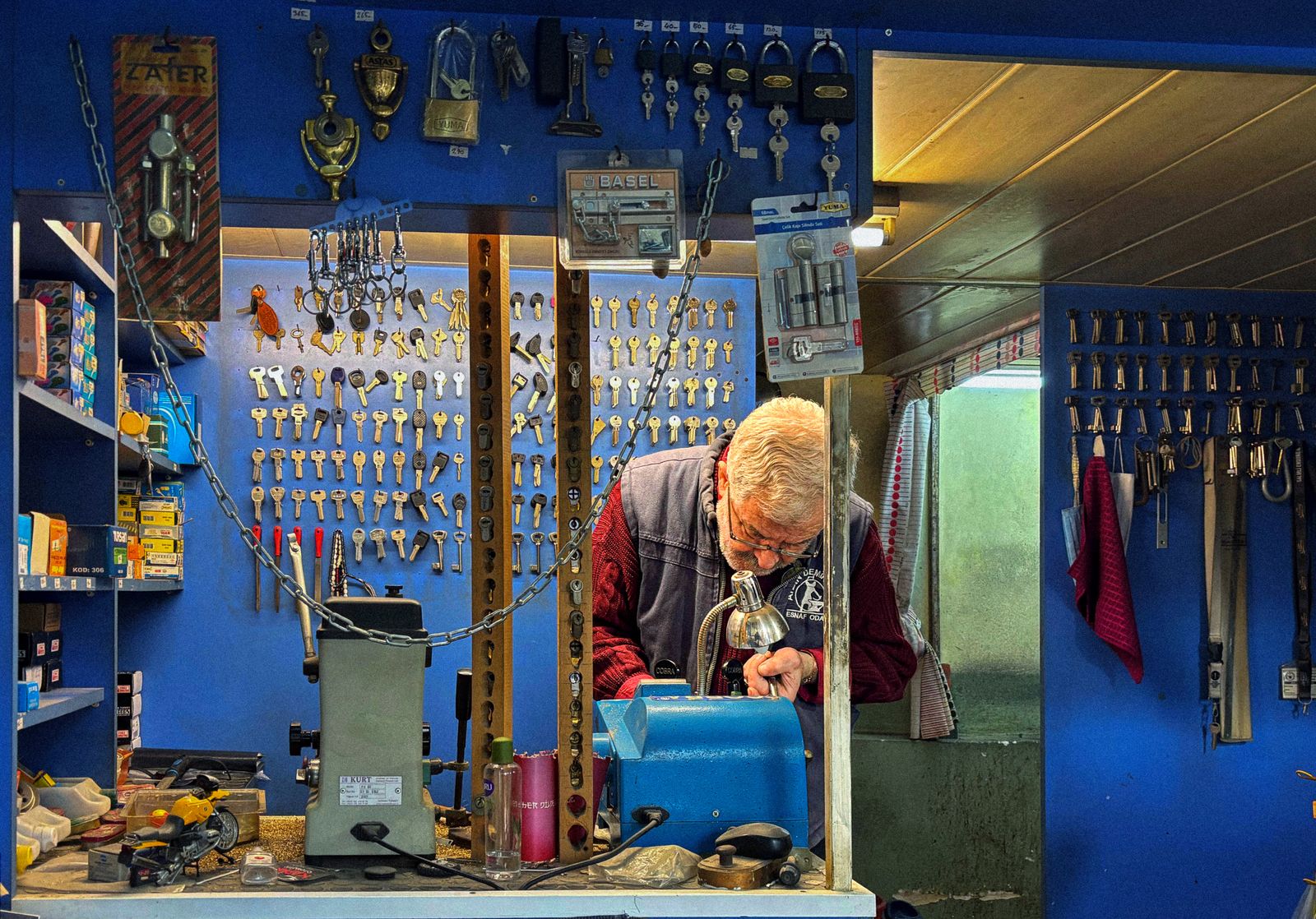 A locksmith fitting a new lock on a front door
