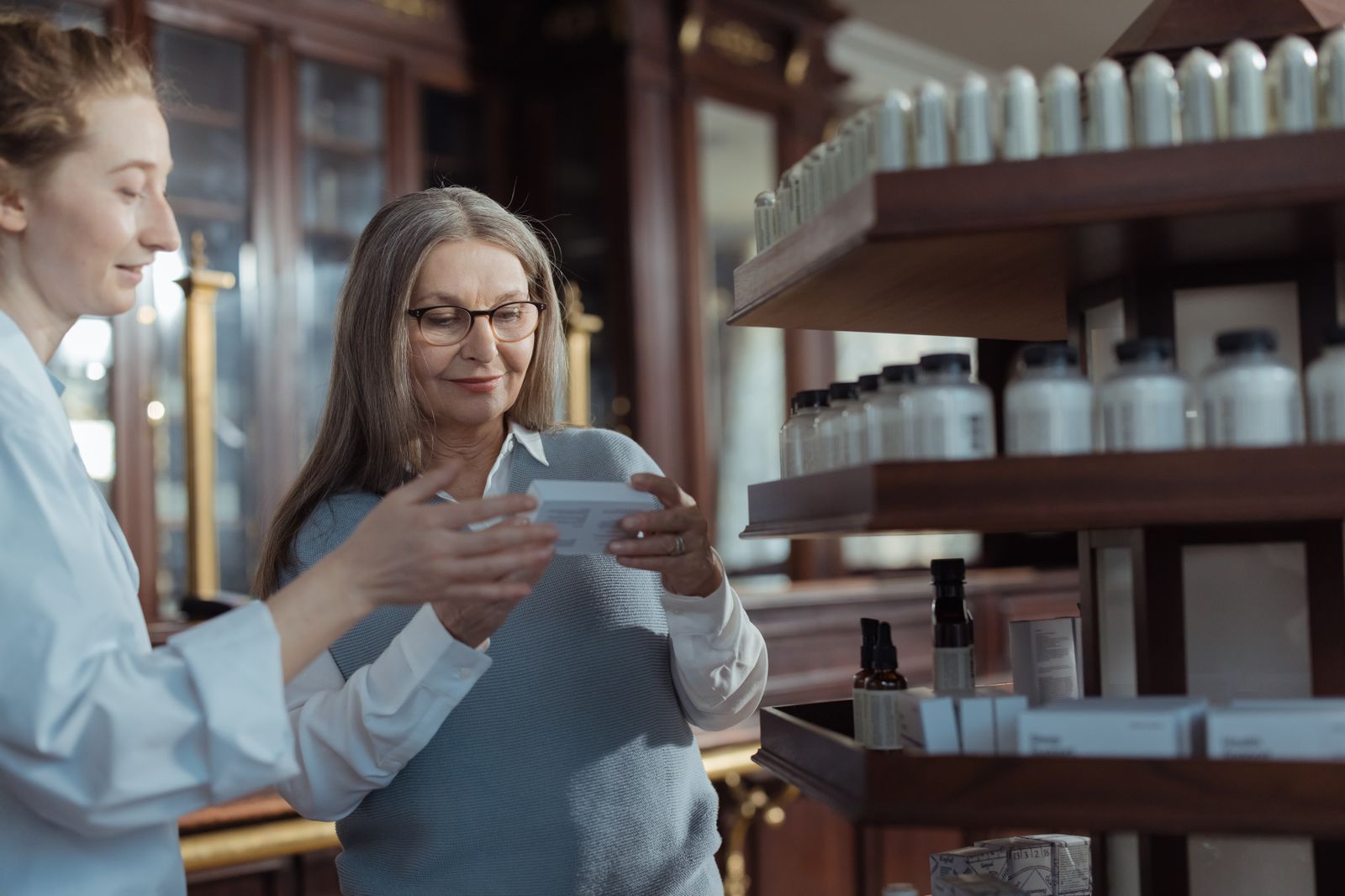 A pharmacist at the counter of the pharmacy