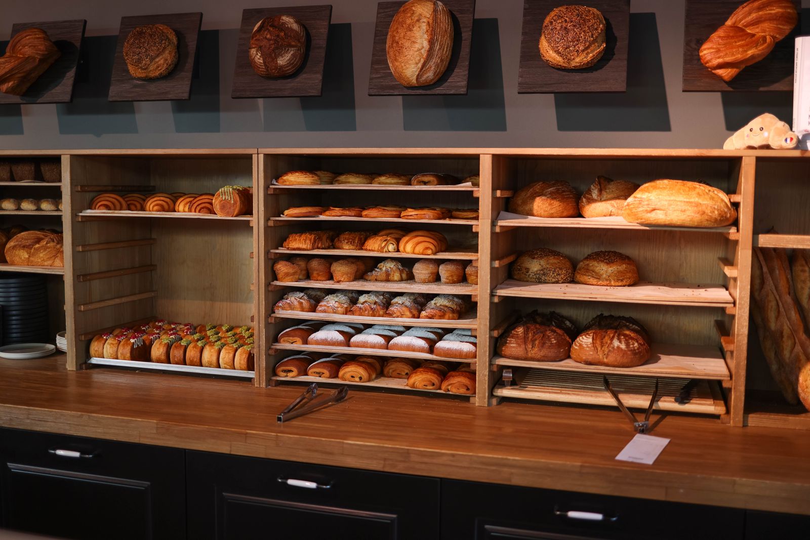 Shelves of fresh bread and pastries behind the bakery counter