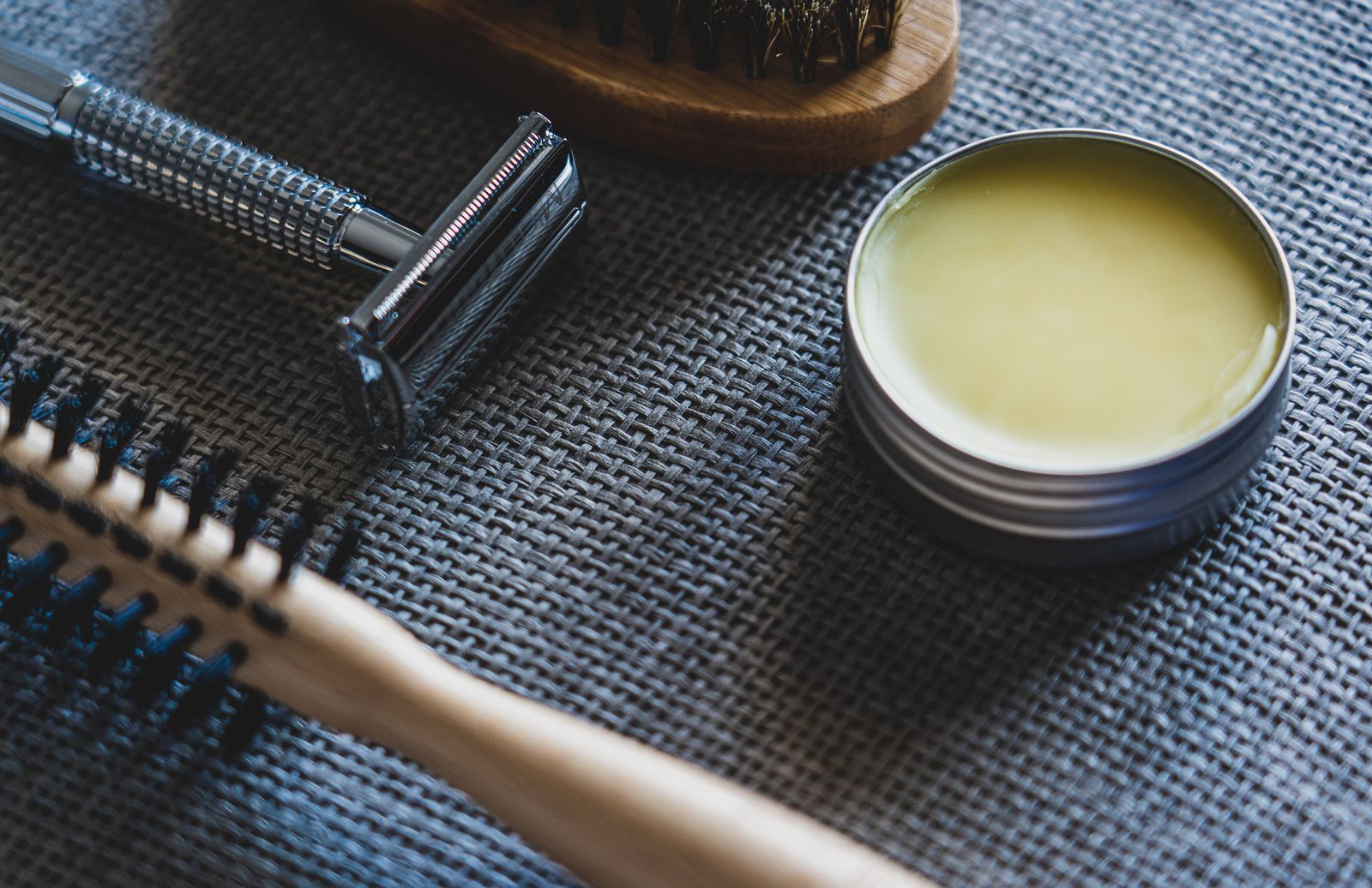 Hair and beard products on a wooden shelf