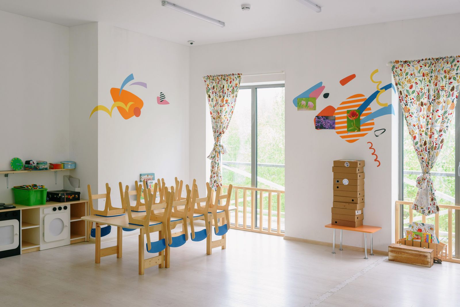 Illustration of a bright nursery playroom with toys and a reading rug