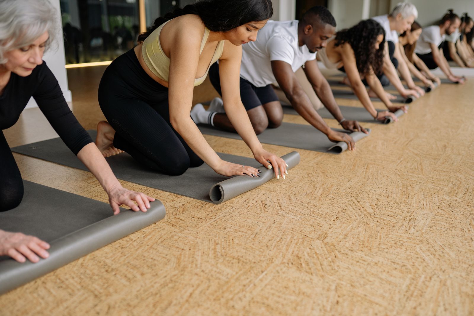 Bright yoga studio with arched windows, mats and props