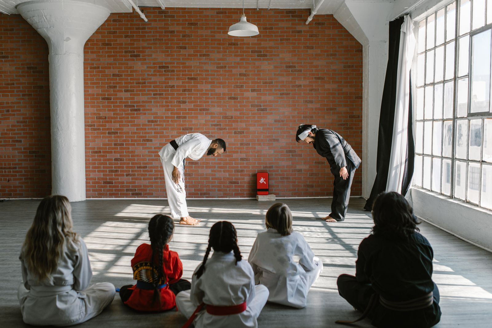 Instructor and students on the mats in the dojo