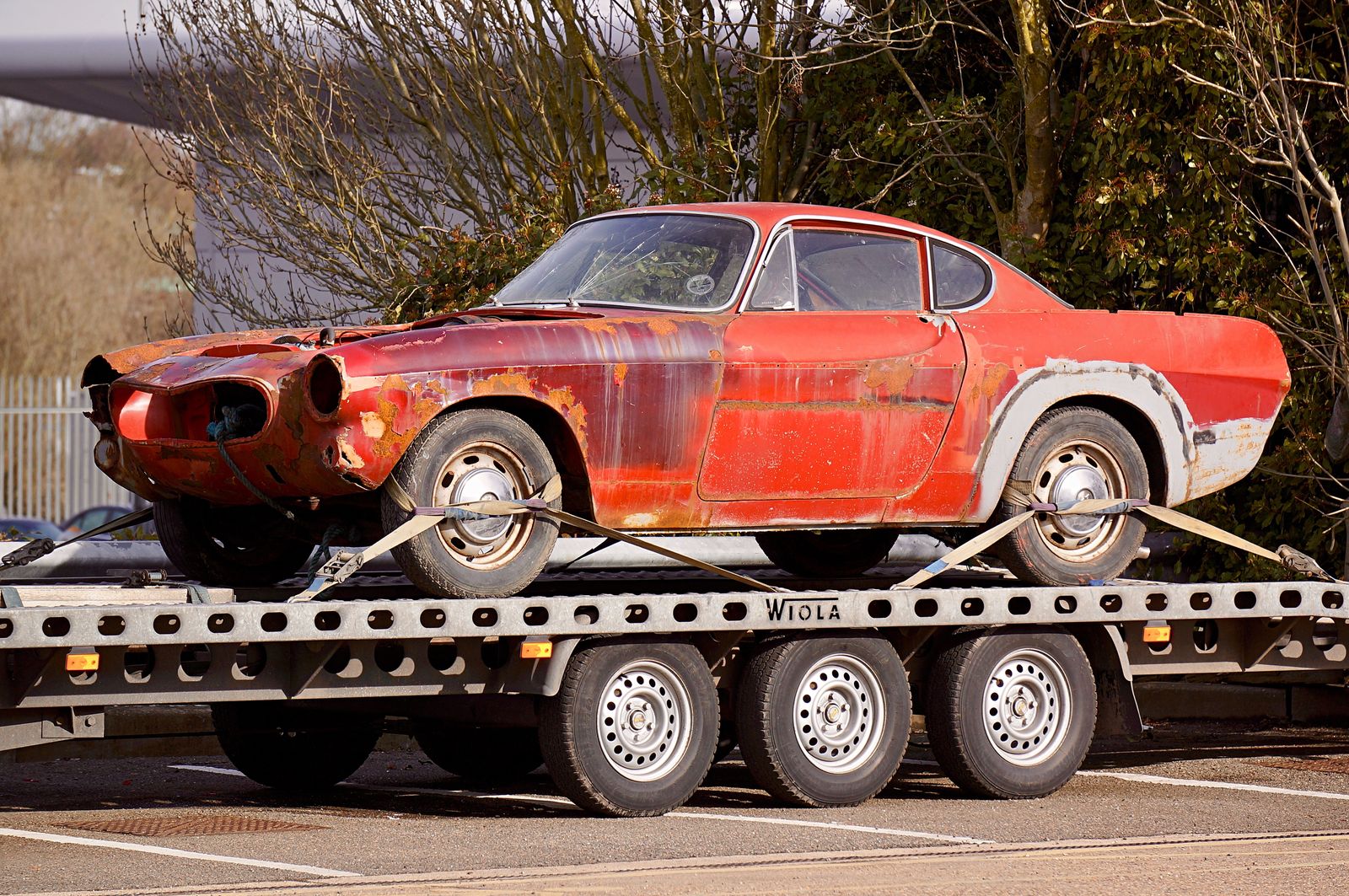 A flatbed truck carrying a car