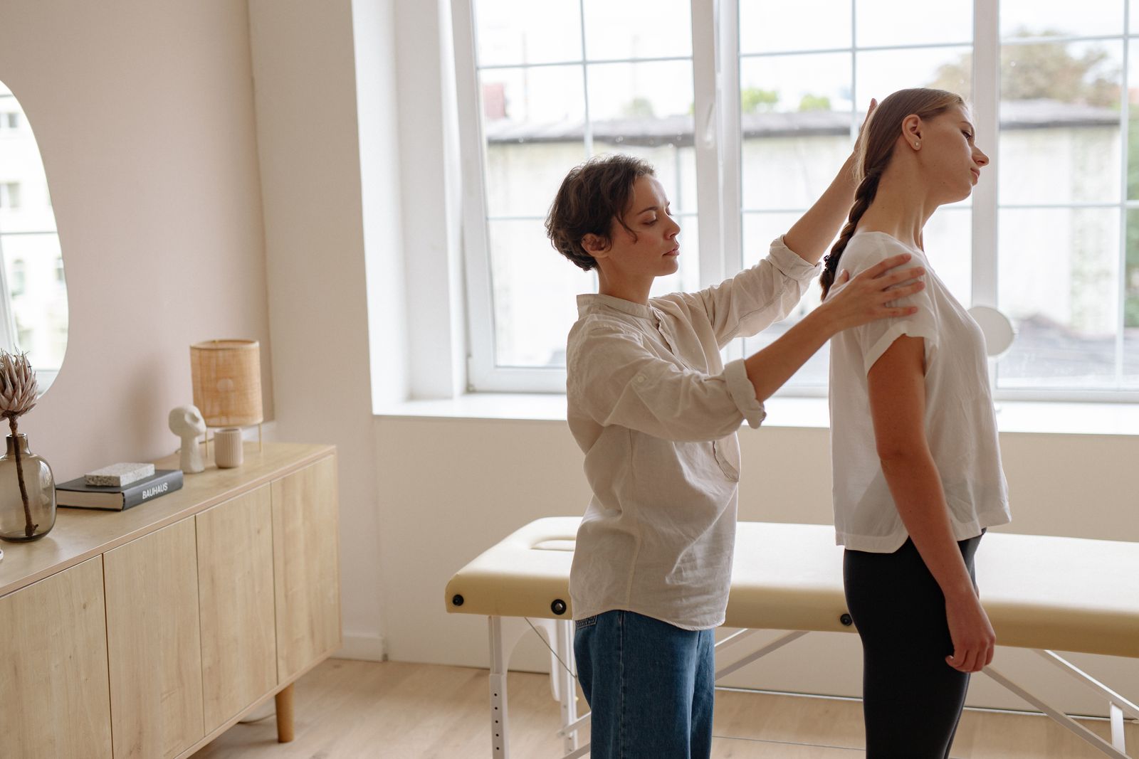 A chiropractor checking a patient’s posture