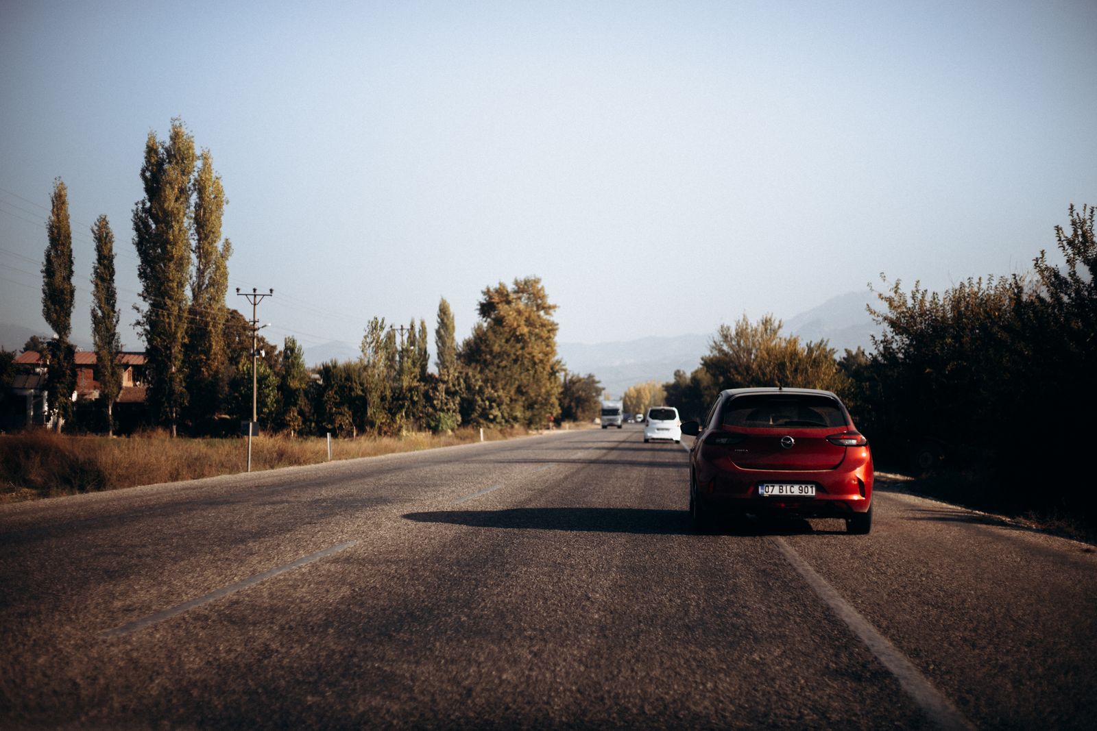 A small driving school car on a winding country road