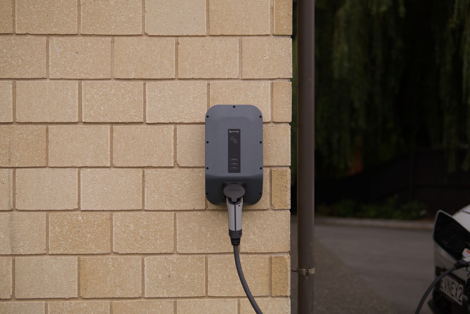 A home EV charger mounted on a wall
