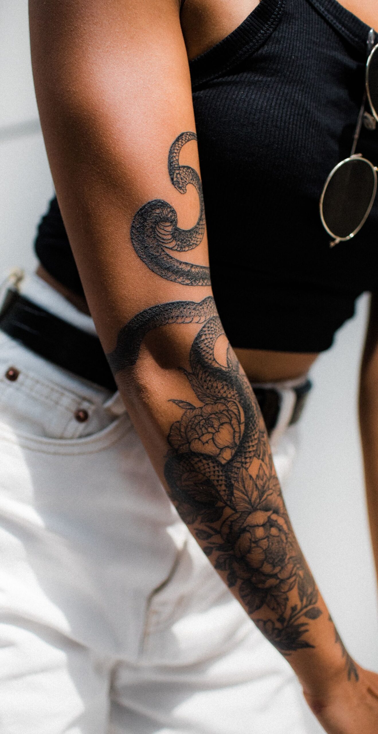 A blackwork snake tattoo on a forearm