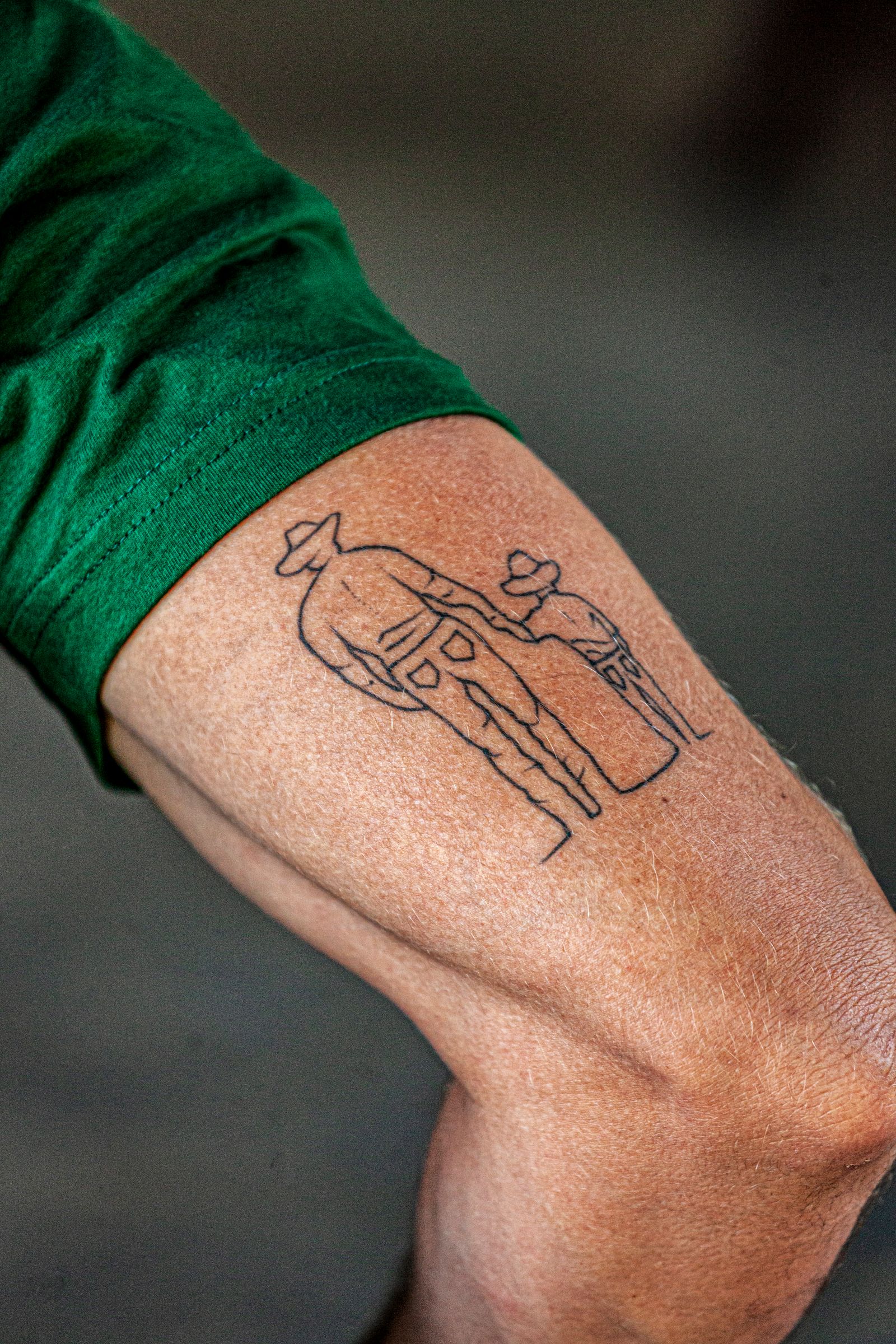 A small minimal line work tattoo on an arm