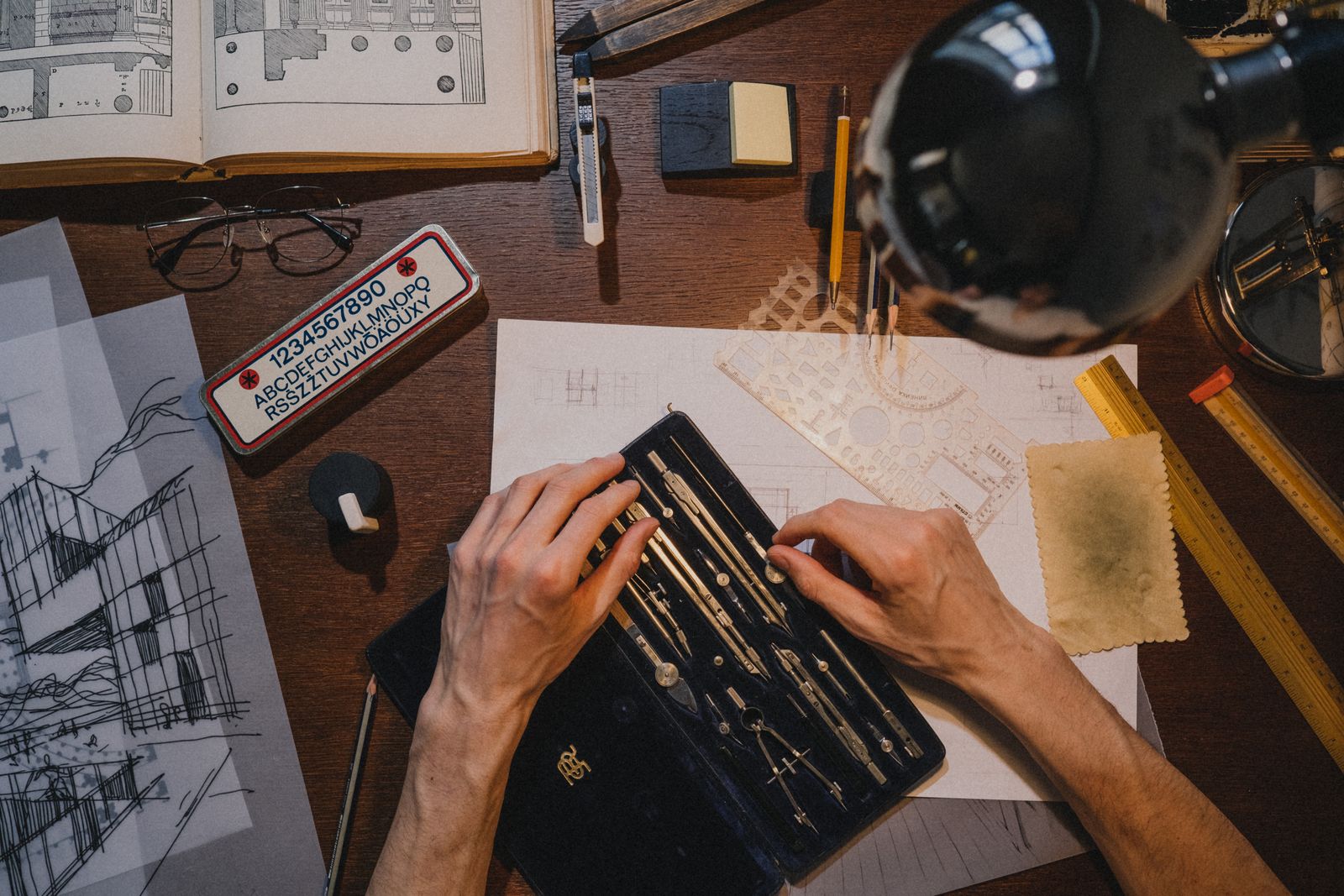 Drawings, a scale ruler and a pencil on the studio desk