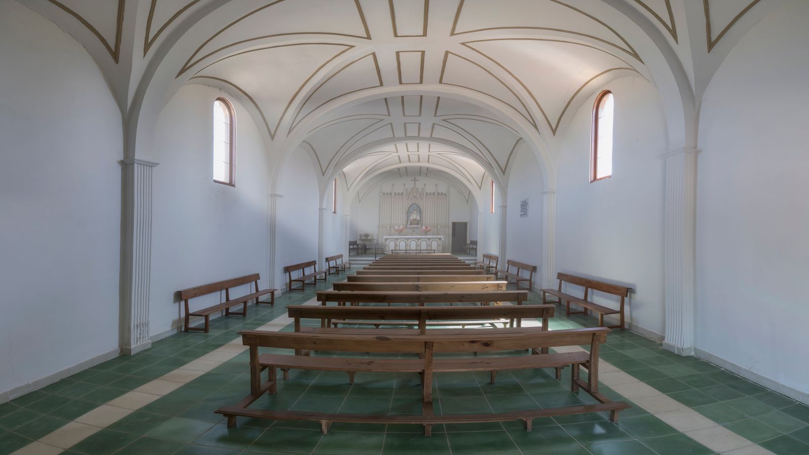 Our chapel with rows of seats and a tall window
