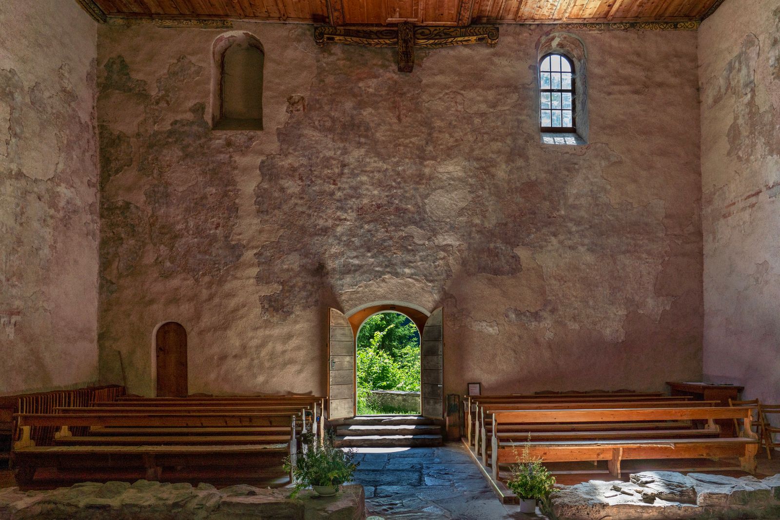 The open front door of the church with light coming through