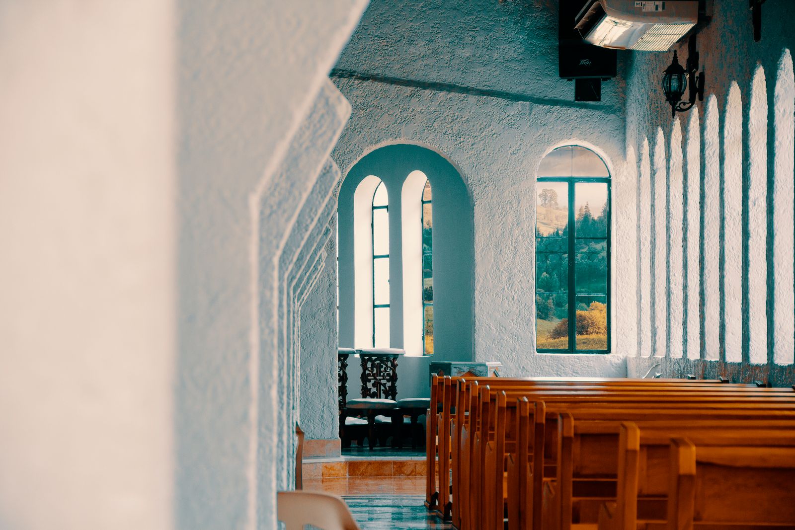 The church building, a simple hall with tall windows and an open door