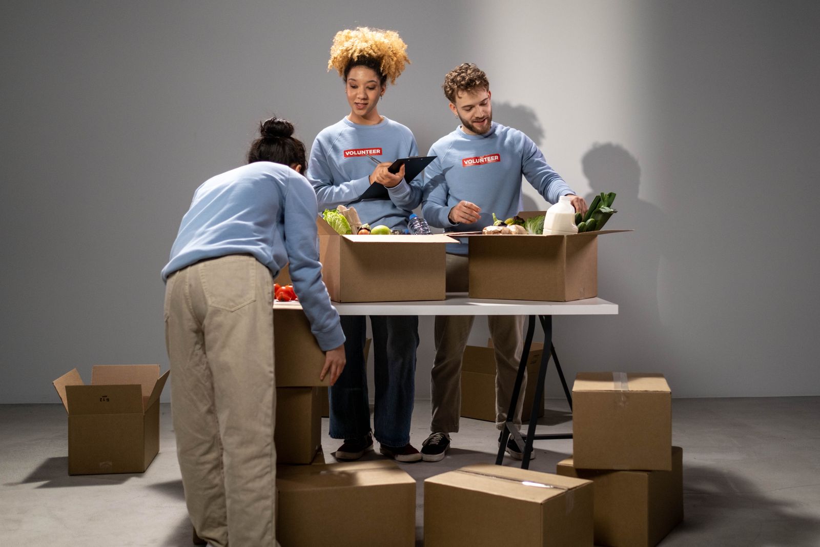 Volunteers passing on a box of food