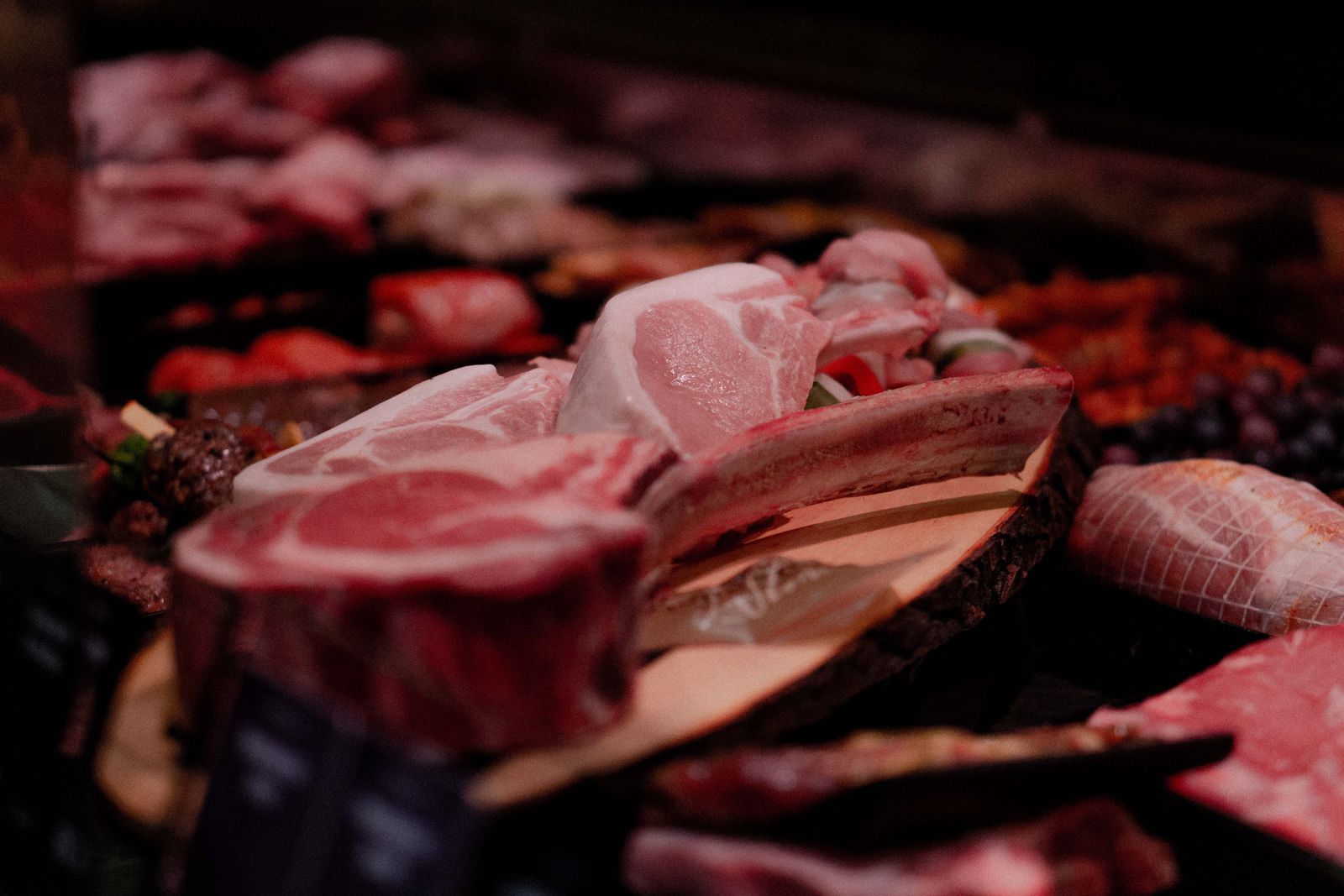 The meat counter with trays of steaks, roasts, sausages and chicken