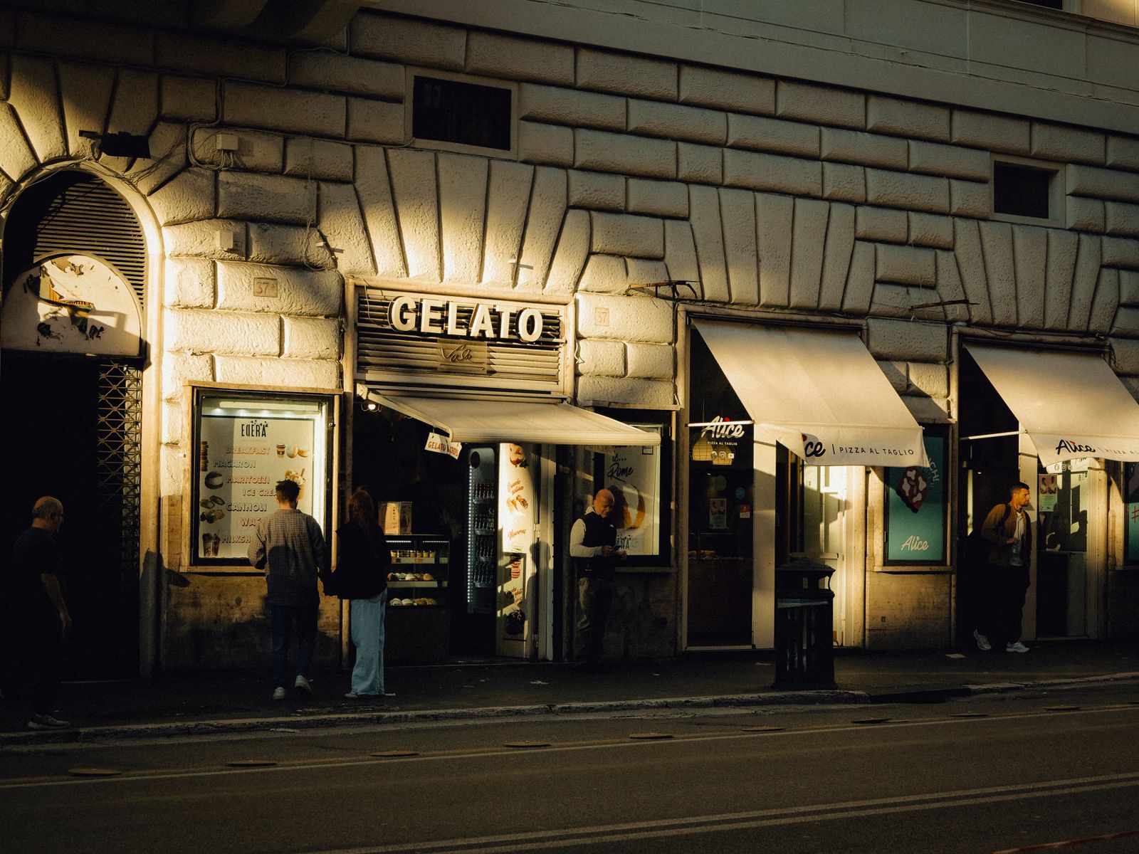 The gelato shop front lit up in the evening