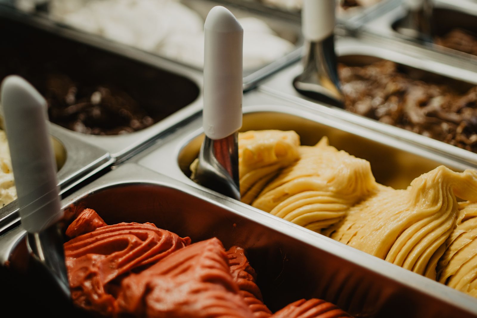 Tubs of gelato in the counter, seen from above