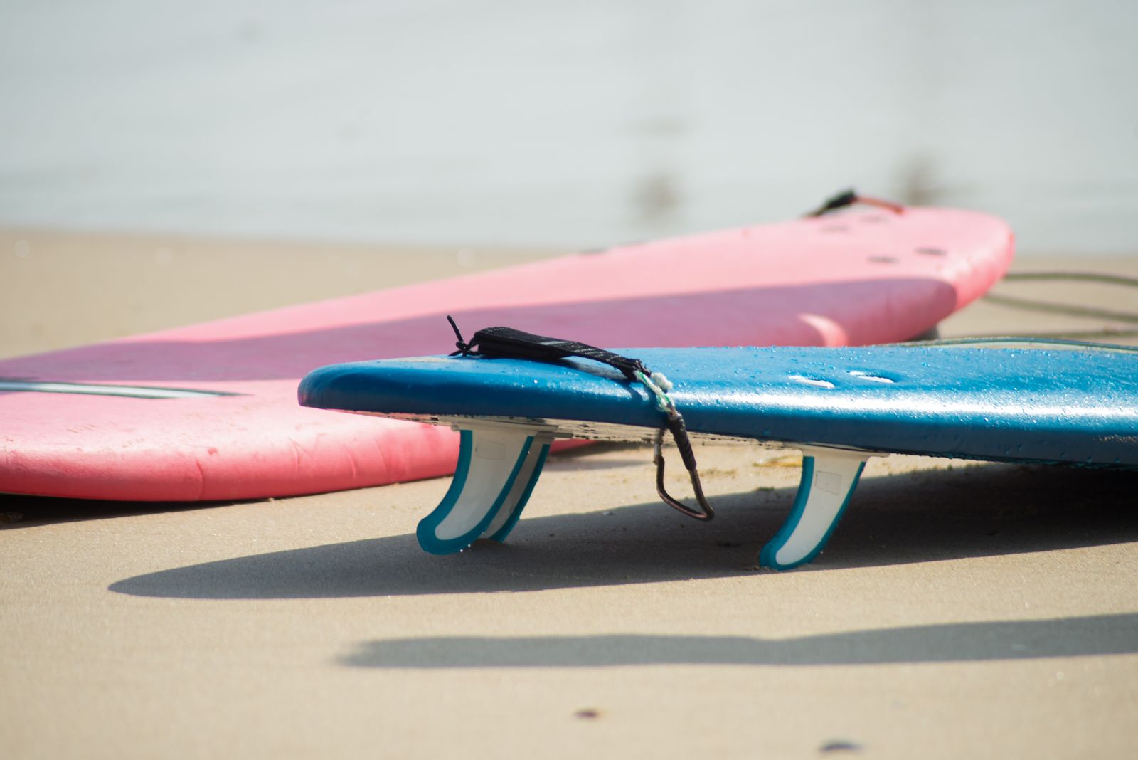 Hire wetsuits drying on the rail outside the hut
