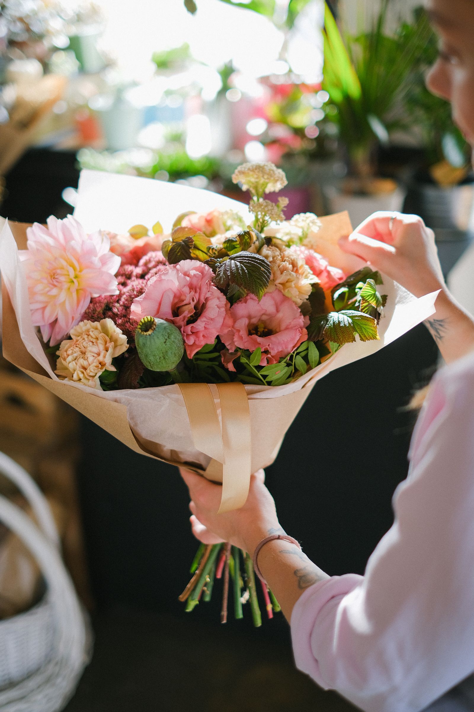 Florist holding a fresh hand-tied bouquet
